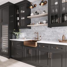 a kitchen with black cabinets and marble counter tops, gold faucets and brass sinks