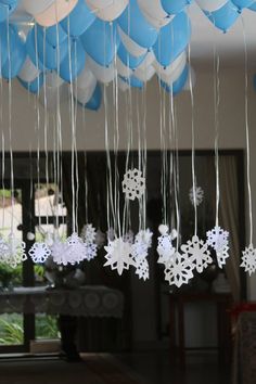 snowflakes and balloons are hanging from the ceiling