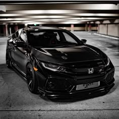 a black car parked in a parking garage