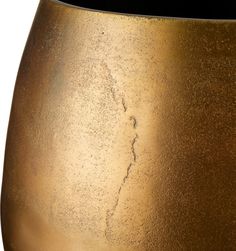 a close up view of a gold colored vase