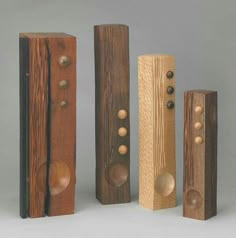 four wooden speakers are lined up in a row