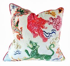 a white pillow with red and green designs on it