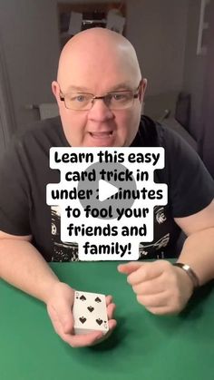 a man sitting at a table holding up two dices with the words learn this easy card trick in under minutes to fool your friends and family