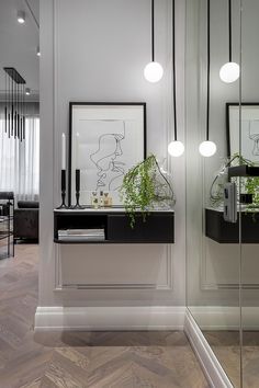 a white room with mirrors and plants on the wall in front of it, along with other decor items