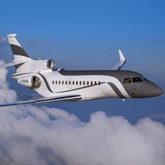 an airplane flying in the sky above some clouds