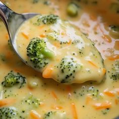 a spoon full of broccoli and cheese soup