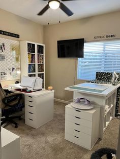 an office with two desks and a ceiling fan