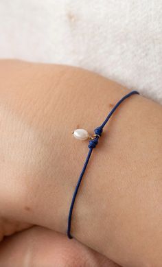 When your radiant love and inner beauty touches the lives of others, the world is your oyster. With a natural pearl charm on a deep blue cord, the oyster contemplation cord bracelet is a message of the power you contain to create incredible beauty and wonder from within your soul. Material 14k recycled yellow gold Freshwater pearl Navy blue nylon cord Details Bluboho is a fine jewelry company that carries ethically sourced, raw and refined jewelry pieces. Bluboho creates jewelry and an experience worthy of the moments they mark. Each piece tells a story. Each experience is a memory in the making. Made in Toronto. Adjustable Blue Oyster Bracelet Jewelry, Delicate Gold Oyster Bracelet, Adjustable Gold Oyster Bracelet, Timeless Oyster Bracelet, Luxury Gold-tone Oyster Bracelet, The Lives Of Others, Inner Beauty, Pearl Charms, Cord Bracelets