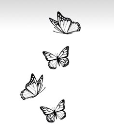 three butterflies flying in the air with one on its back and one on its side