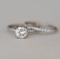 two white gold engagement rings with diamonds on them