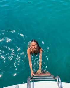 a woman standing on the edge of a boat