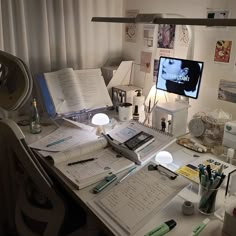 a cluttered desk with many papers on it