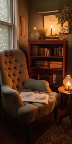 a chair with an open book on it in front of a window filled with books