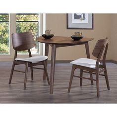 two chairs and a table in a room with wood flooring on the ground, one chair has a white upholstered seat