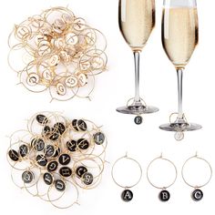 two champagne flutes and some wine glasses with numbers on them next to gold wire bracelets