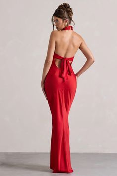 a woman in a red dress with her back to the camera