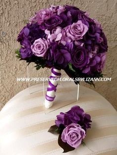 a bouquet of purple flowers sitting on top of a cake