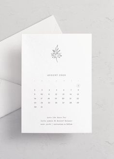 a white calendar card with a plant on the front, and an envelope in the back