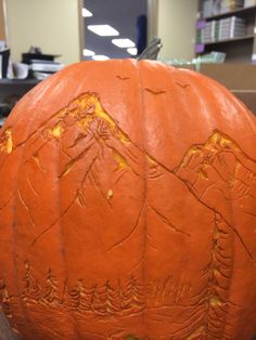 a carved pumpkin sitting on top of a wooden table