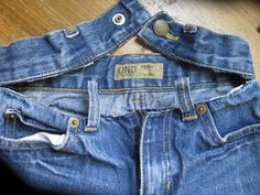 a pair of blue jeans sitting on top of a wooden floor