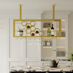 a kitchen with white cabinets and marble counter tops, wine glasses hanging from the ceiling