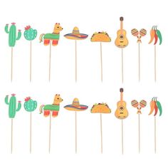 mexican themed cake toppers on sticks with cactus and tortilla decorations in the shape of guitars