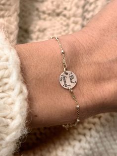 a woman's arm with a personalized bracelet on it