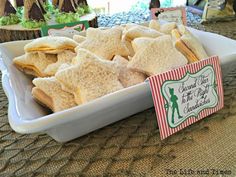 a tray filled with crackers sitting on top of a table next to a sign