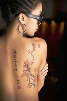 a woman with tattoos on her back