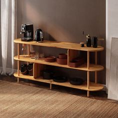 a wooden shelf with plates and cups on it