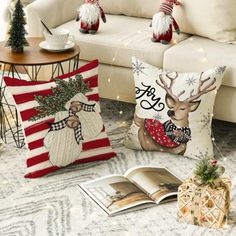 christmas pillows on the floor in front of a couch