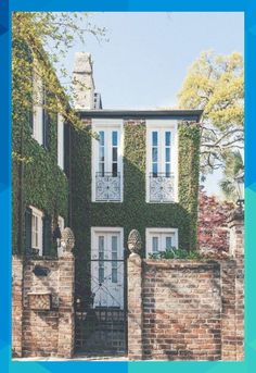 an old brick house with ivy growing on it's walls and shuttered windows