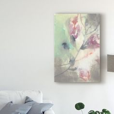 a painting hanging on the wall above a white couch