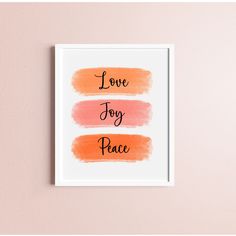 a framed print with the words love, joy and peace in different colors on it