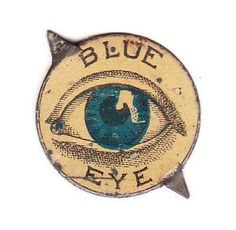 an old blue eye pin with the words,'blue eye'written on it