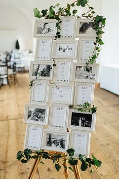 an easel with pictures and greenery on it in front of a wooden floor