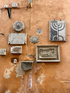 the wall is covered with many different items and decorations, including menorah plates