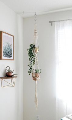 three macrame plant hangers in the corner of a room with white walls