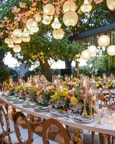 a long table is set up with many plates and place settings for an elegant dinner