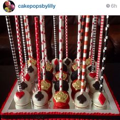 there are many cupcakes on the table with red and white striped straws