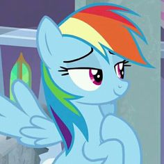 the rainbow pony is standing in front of a mirror with its eyes closed and it's hair blowing