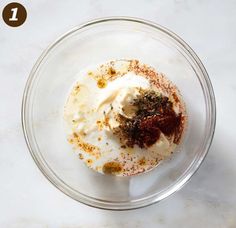 a glass bowl filled with food on top of a table