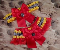 two red and yellow garters laying in the sand