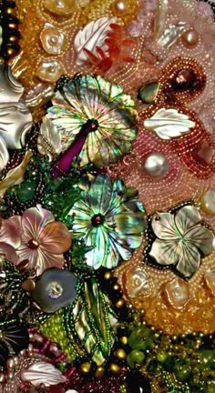 many different colored beads and flowers on a table