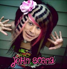 a girl with pink hair and black and white stripes on her head is making the peace sign