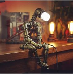 a lamp that is sitting on top of a wooden table in front of a desk