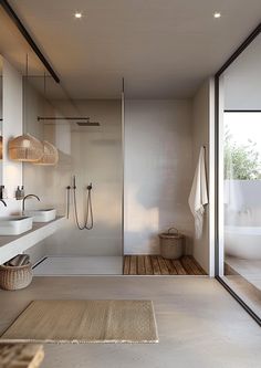 a modern bathroom with large glass doors and wooden flooring is pictured in this image