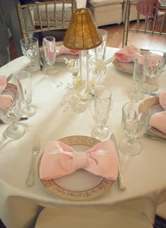 an image of a table setting with pink napkins and place settings on the table