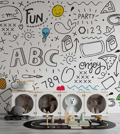 the children's playroom is decorated with black and white wallpaper, including toys