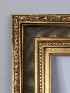 an ornate gold frame hanging on the wall